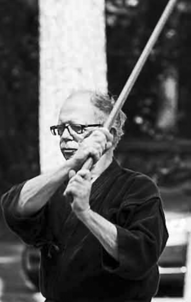 Hall Sensei holding a bokken in hidari hasso no kamae (sword above left shoulder)